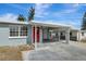 Newly renovated home with a carport and red front door at 10515 118Th Ave, Largo, FL 33773