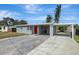 Newly renovated home with a carport and red front door at 10515 118Th Ave, Largo, FL 33773