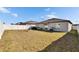 Back yard featuring a swing set, grill and white fence at 11210 Kelly Green Ave, Wimauma, FL 33598