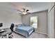 Bedroom with neutral walls, carpet, fan, window with blinds, and closet at 11210 Kelly Green Ave, Wimauma, FL 33598