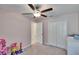 A well-lit bedroom with a ceiling fan, a closet, and room for a variety of furnishings at 11210 Kelly Green Ave, Wimauma, FL 33598