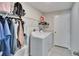 Laundry room featuring a washer, dryer and wire shelving for storage at 11210 Kelly Green Ave, Wimauma, FL 33598