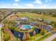 Aerial view of the neighborhood amenities including a pool, pond and recreational area at 13001 Prestwick Dr, Riverview, FL 33579