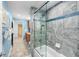 Modern bathroom featuring gray tile, glass shower door, and blue accents at 13001 Prestwick Dr, Riverview, FL 33579