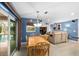 Open concept dining area with wooden table and chairs, open to living room and kitchen at 13001 Prestwick Dr, Riverview, FL 33579