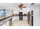 Modern kitchen with stainless steel appliances, white cabinetry, and granite countertops at 13001 Prestwick Dr, Riverview, FL 33579