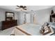 Neutral toned main bedroom with full dresser and access to bathroom at 13001 Prestwick Dr, Riverview, FL 33579