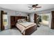 Comfortable main bedroom featuring a ceiling fan, slider to the pool, and built-in shelving at 13001 Prestwick Dr, Riverview, FL 33579