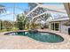 A beautiful screened-in pool and spa provide a relaxing outdoor living space at 13001 Prestwick Dr, Riverview, FL 33579