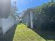 Landscaped side yard with grassy area and mature trees at 13184 73Rd Ave, Seminole, FL 33776