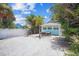 Large backyard with gravel parking and patio area at 13405 Gulf Blvd, Madeira Beach, FL 33708