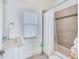 Clean bathroom with a shower/tub combo and updated finishes at 13405 Gulf Blvd, Madeira Beach, FL 33708