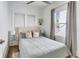 Cozy bedroom with light-grey bedding and large window at 13405 Gulf Blvd, Madeira Beach, FL 33708