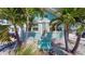 Charming light blue beach cottage with a front porch at 13405 Gulf Blvd, Madeira Beach, FL 33708