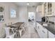 Kitchen with dining area and view into living room at 13405 Gulf Blvd, Madeira Beach, FL 33708