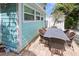 Outdoor patio with table and chairs next to house at 13405 Gulf Blvd, Madeira Beach, FL 33708