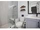 Modern bathroom with a walk-in shower, toilet and floating shelves at 1501 N Morgan St # 7, Tampa, FL 33602