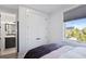 Bedroom with white closet doors and view into modern bathroom at 1501 N Morgan St # 7, Tampa, FL 33602