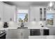 Modern kitchen with white cabinets, quartz countertops, and a farmhouse sink at 1501 N Morgan St # 7, Tampa, FL 33602