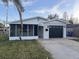 Updated single story home with a modern garage door and screened porch at 1798 Shore Acres Ne Blvd, St Petersburg, FL 33703