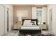 Bedroom with dark bed, nightstands, and closet at 18175 Serene Lake Loop, Lutz, FL 33548