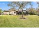 Spacious backyard with lush lawn and screened enclosure at 19116 Sweet Clover Ln, Tampa, FL 33647