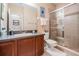 Bathroom with a shower, toilet, and wood cabinets at 19116 Sweet Clover Ln, Tampa, FL 33647