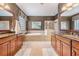 Double vanity bathroom with soaking tub, walk-in shower, and granite countertops at 19116 Sweet Clover Ln, Tampa, FL 33647