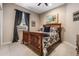 Bedroom with a queen bed, wooden frame, and window with dark curtains at 19116 Sweet Clover Ln, Tampa, FL 33647