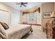 Bright bedroom with window seat and double doors to the hallway at 19116 Sweet Clover Ln, Tampa, FL 33647