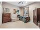 Small bedroom with a twin bed, dresser, and ottoman at 19116 Sweet Clover Ln, Tampa, FL 33647