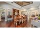 Elegant dining room with hardwood floors, built-in shelving, and rustic table at 19116 Sweet Clover Ln, Tampa, FL 33647