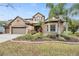 Beautiful two-story home with stone exterior and landscaping at 19116 Sweet Clover Ln, Tampa, FL 33647