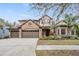 Beautiful two-story home with stone exterior and landscaping at 19116 Sweet Clover Ln, Tampa, FL 33647