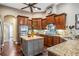 Island kitchen with wood cabinets, granite counters, and stainless steel appliances at 19116 Sweet Clover Ln, Tampa, FL 33647