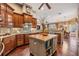 Large kitchen with an island, wood cabinets, and hardwood floors at 19116 Sweet Clover Ln, Tampa, FL 33647