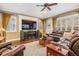 Living room with hardwood floors, a large TV, and comfy seating at 19116 Sweet Clover Ln, Tampa, FL 33647