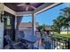 Relaxing balcony features a ceiling fan, tile flooring, and wrought iron furniture overlooking the pool at 200 Brightwaters Ne Blvd, St Petersburg, FL 33704