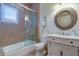 Elegant bathroom with granite countertop vanity, decorative mirror, tile shower, and plantation shutters at 200 Brightwaters Ne Blvd, St Petersburg, FL 33704