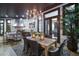 Stunning dining room with chandelier overlooks the outdoor kitchen, and features an adjacent covered patio at 200 Brightwaters Ne Blvd, St Petersburg, FL 33704