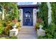 Close up of secure gated front entry and stone facade, surrounded by lush greenery at 200 Brightwaters Ne Blvd, St Petersburg, FL 33704