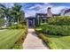 Beautifully landscaped front yard with lush grass, colorful flowers, and a stone path leading to the entrance at 200 Brightwaters Ne Blvd, St Petersburg, FL 33704