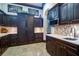 Stunning dark wood kitchen with stainless steel appliances and mosaic tile backsplash, perfect for culinary enthusiasts at 200 Brightwaters Ne Blvd, St Petersburg, FL 33704