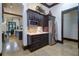 Kitchen featuring custom cabinetry, stainless steel refrigerator, and bar area at 200 Brightwaters Ne Blvd, St Petersburg, FL 33704