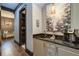 Modern wet bar area featuring granite countertops, custom cabinetry, and stylish lighting perfect for entertaining guests at 200 Brightwaters Ne Blvd, St Petersburg, FL 33704