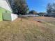 Large backyard space with unkempt grass and a white fence at 2226 Ridgemore Dr, Valrico, FL 33594