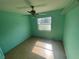 Bedroom with light teal walls and laminate wood floors at 2226 Ridgemore Dr, Valrico, FL 33594