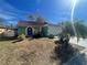 Cute green house with a red tile roof and a white garage door at 2226 Ridgemore Dr, Valrico, FL 33594