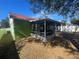 Exterior view of a house with a screened porch and a red roof at 2226 Ridgemore Dr, Valrico, FL 33594