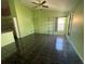 Spacious living room with dark tile floors and a ceiling fan at 2226 Ridgemore Dr, Valrico, FL 33594